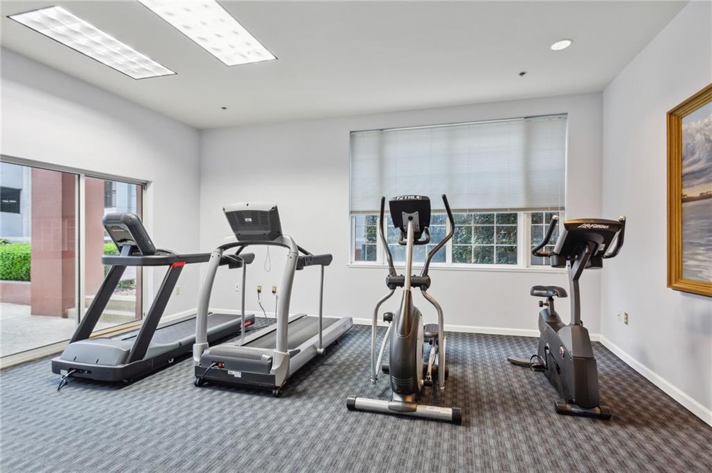 3435 Kingsboro Road Northeast, Unit 1702 Atlanta, GA 30326 - Photo 31 of 35 a room with gym equipment and large mirror