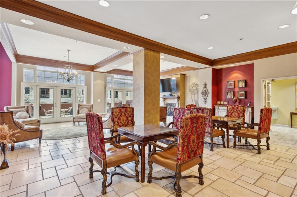 3435 Kingsboro Road Northeast, Unit 1702 Atlanta, GA 30326 - Photo 33 of 35 a view of a dining room and livingroom with furniture wooden floor and a rug