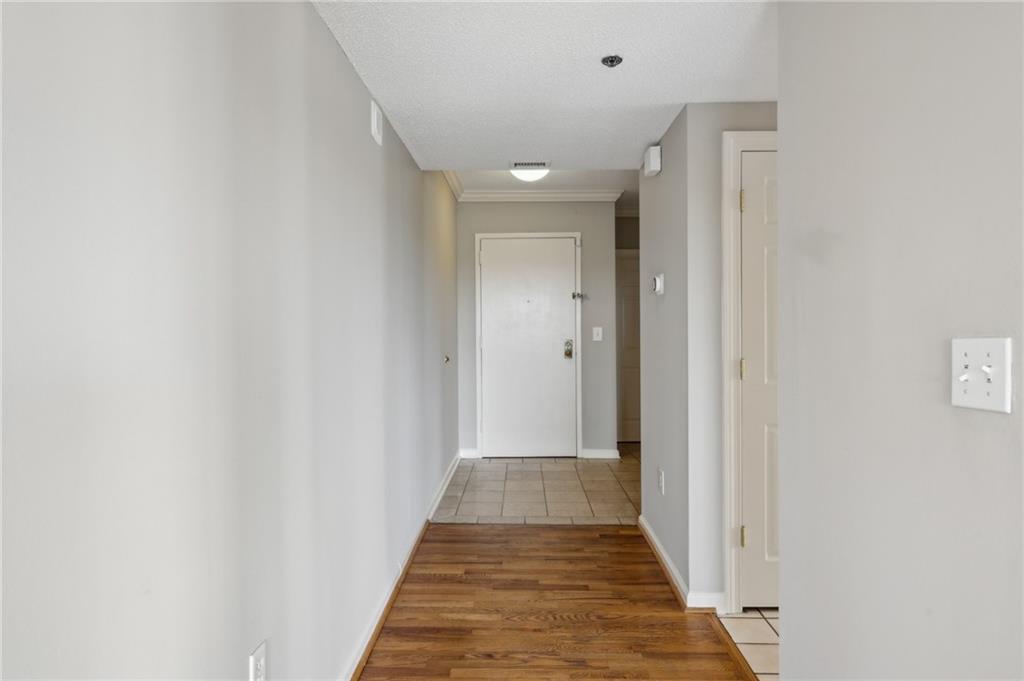 3435 Kingsboro Road Northeast, Unit 1702 Atlanta, GA 30326 - Photo 4 of 35 a view of a hallway with wooden floor