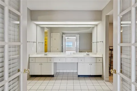 a bathroom with a granite countertop sink and a bathtub