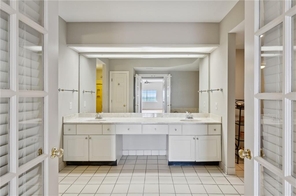 3435 Kingsboro Road Northeast, Unit 1702 Atlanta, GA 30326 - Photo 5 of 35 a bathroom with a sink a mirror and a bathtub