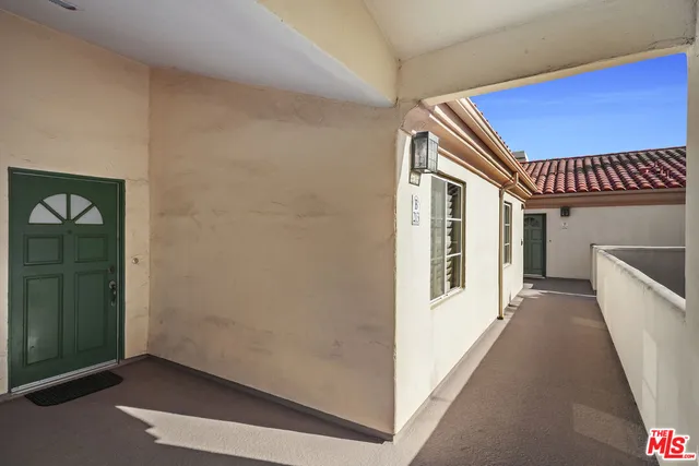 a view of a room with wooden floor and windows