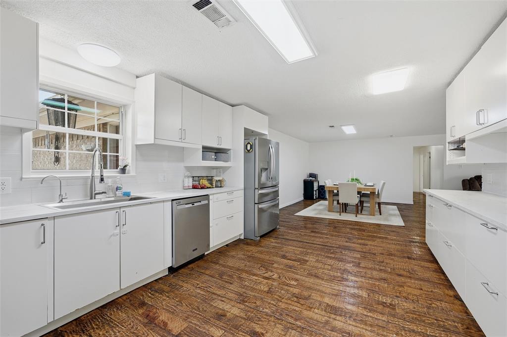 85 Quail Run Road Sherman, TX 75090 - Photo 12 of 31 a large white kitchen with sink stove and refrigerator