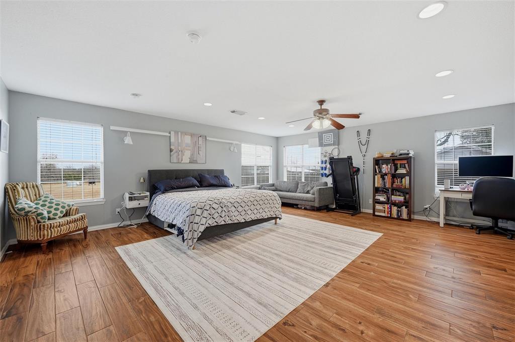 85 Quail Run Road Sherman, TX 75090 - Photo 15 of 31 a spacious bedroom with a bed and wooden floor