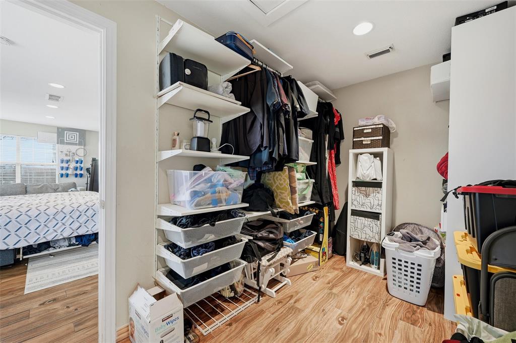 85 Quail Run Road Sherman, TX 75090 - Photo 18 of 31 a view of walk in closet with clothes and shoes