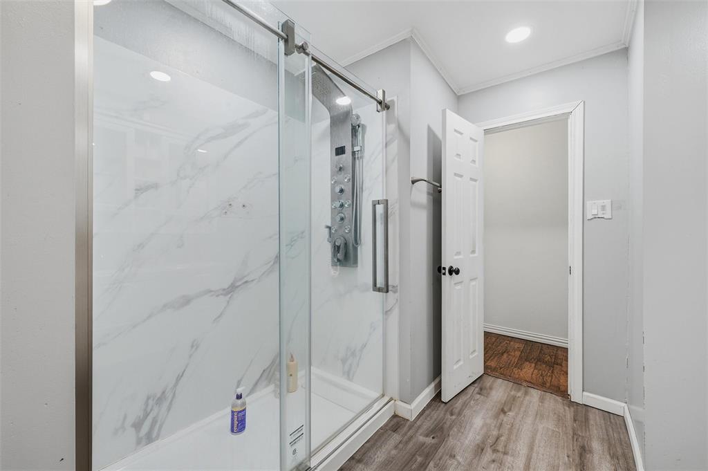 85 Quail Run Road Sherman, TX 75090 - Photo 24 of 31 a bathroom with a shower and a glass door