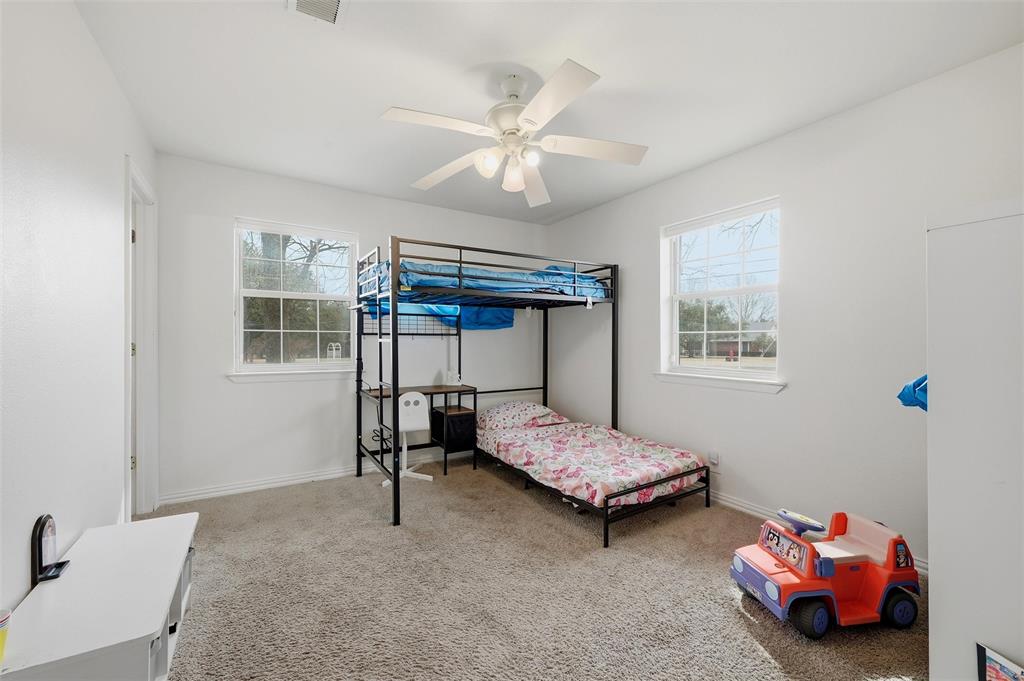85 Quail Run Road Sherman, TX 75090 - Photo 27 of 31 a bedroom with two beds and a window