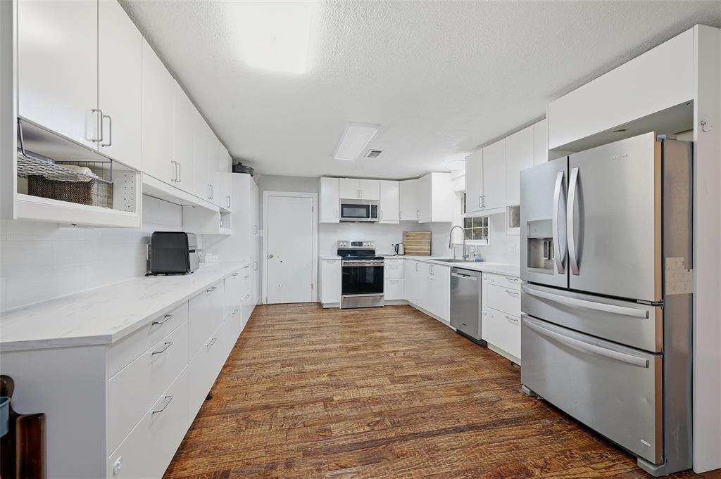 85 Quail Run Road Sherman, TX 75090 - Photo 10 of 31 a kitchen with stainless steel appliances a refrigerator sink and cabinets