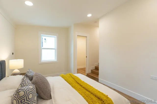 a bedroom with a bed and a window