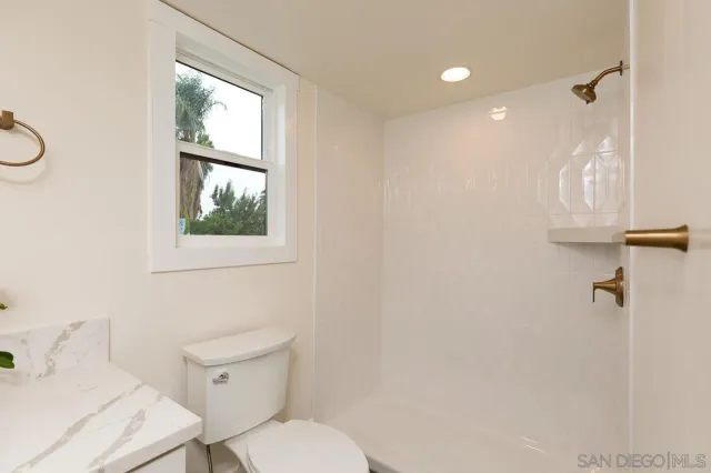 a white toilet sitting next to a bathroom sink