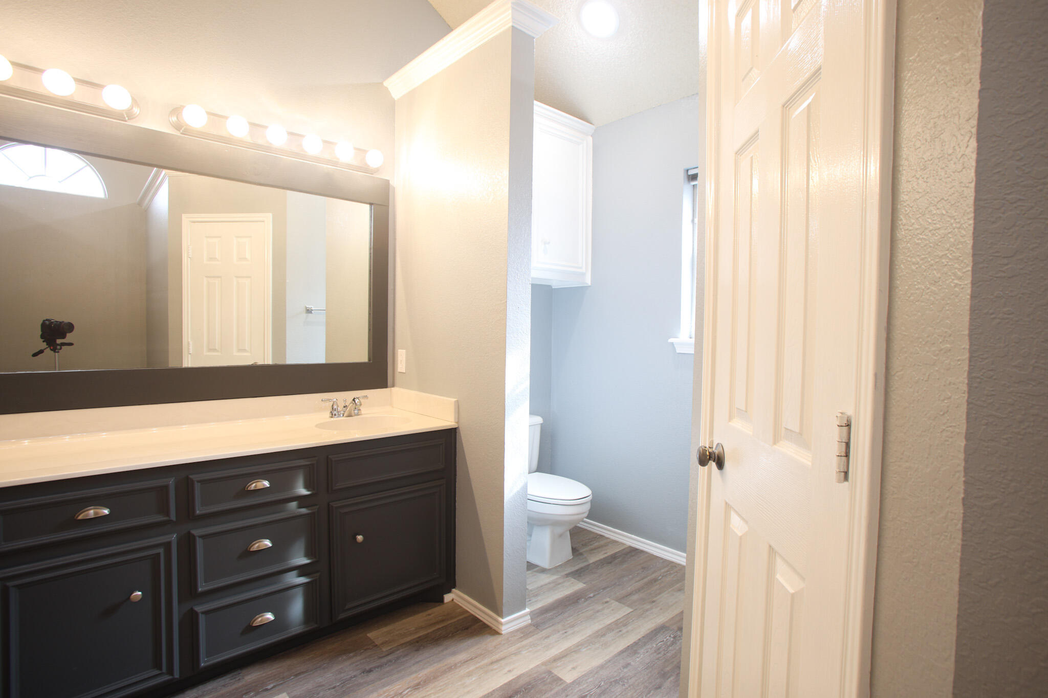 6916 Fulton Avenue Lubbock, TX 79424 - Photo 17 of 24 a bathroom with a granite countertop sink toilet and shower