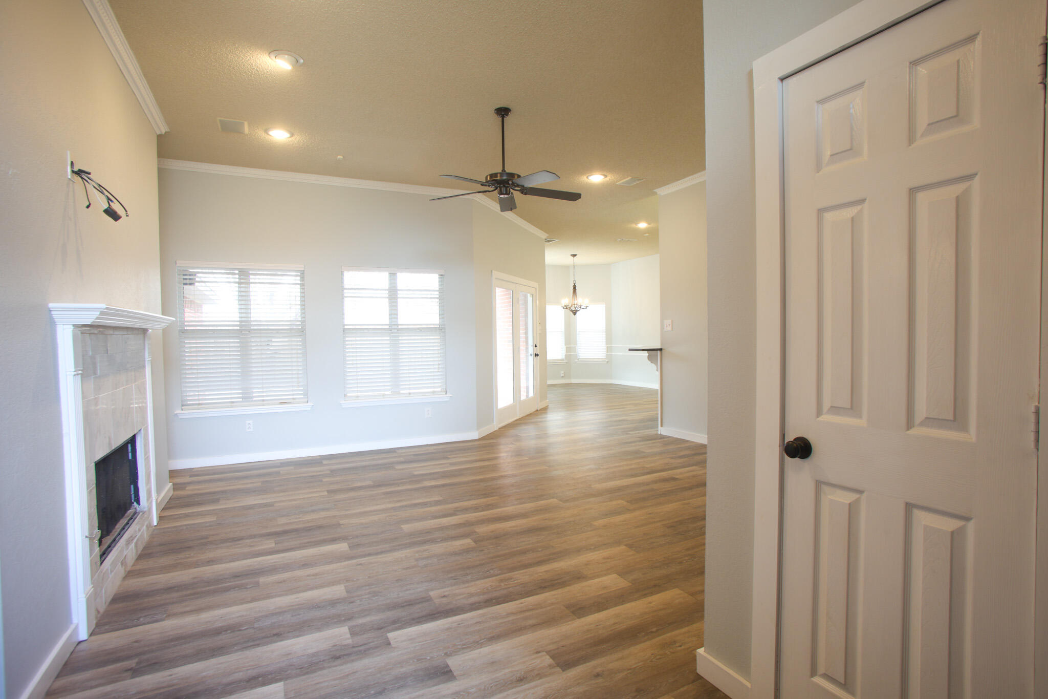 6916 Fulton Avenue Lubbock, TX 79424 - Photo 5 of 24 a view of a hallway with wooden floor and a kitchen