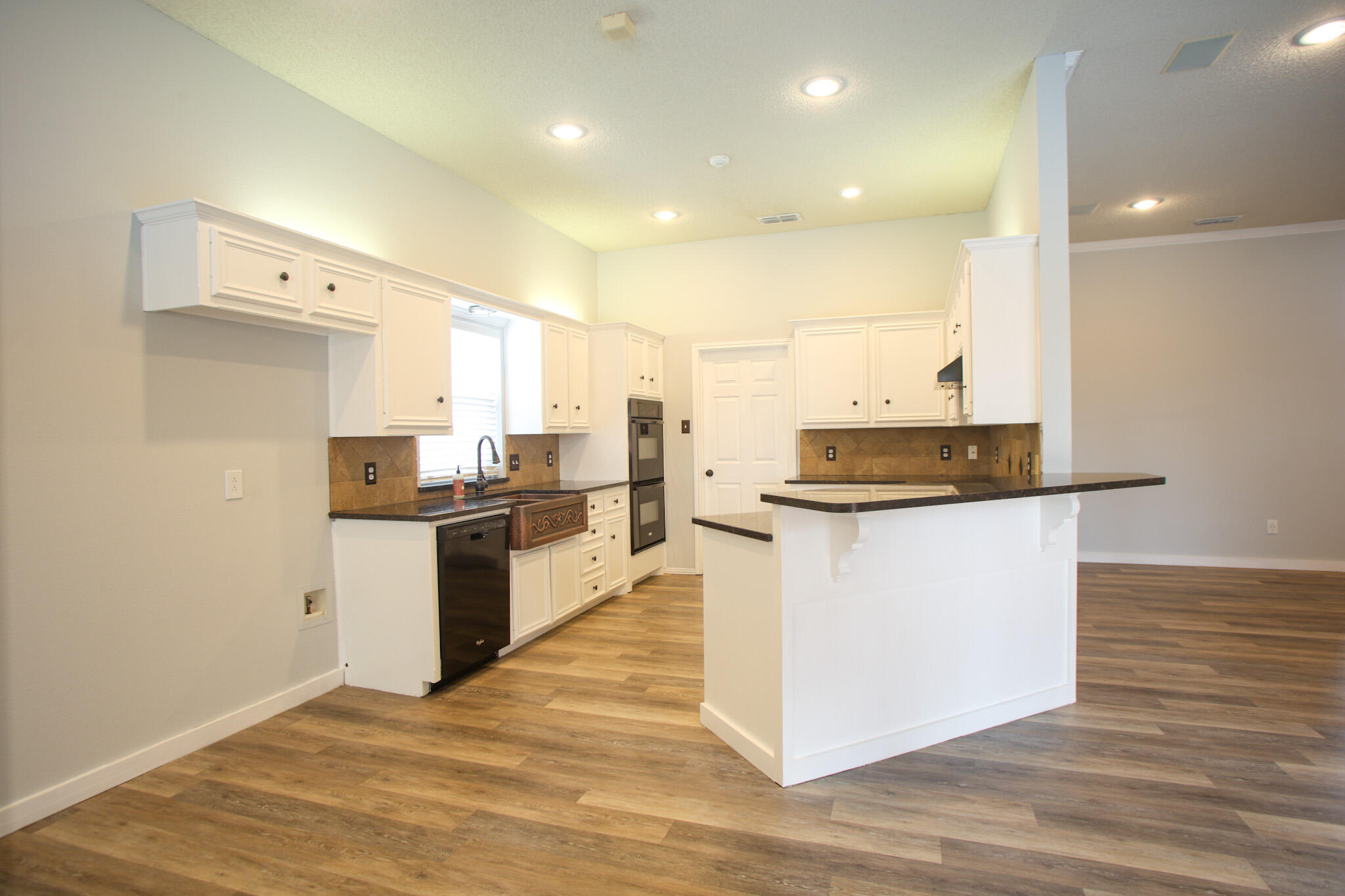 6916 Fulton Avenue Lubbock, TX 79424 - Photo 7 of 24 a kitchen with stainless steel appliances granite countertop a stove a sink and a refrigerator