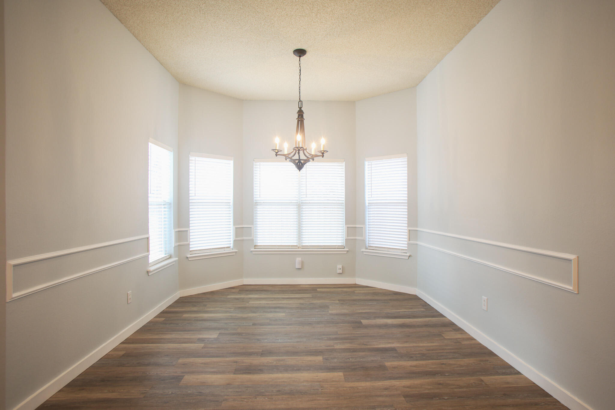 6916 Fulton Avenue Lubbock, TX 79424 - Photo 8 of 24 a view of empty room with wooden floor and fan