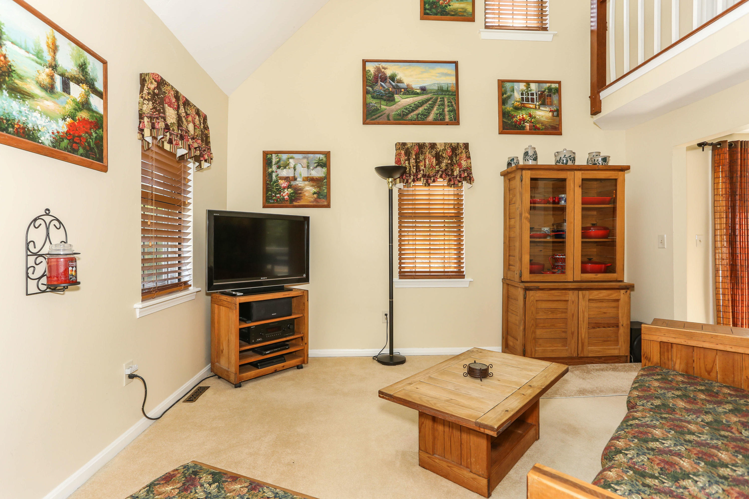 385 Skunknet Road Centerville, MA 02632 - Photo 11 of 32 a living room with furniture and a flat screen tv