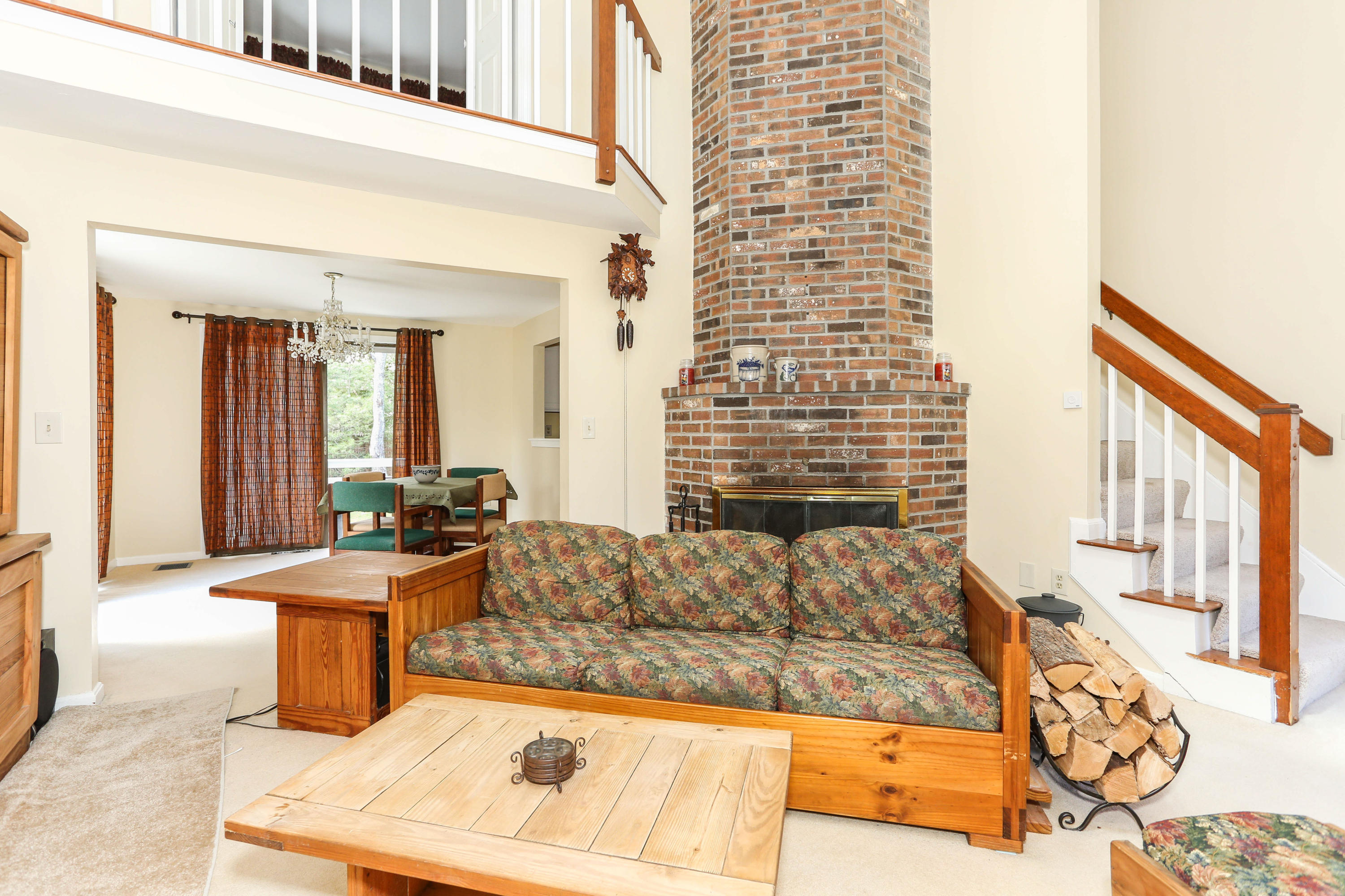 385 Skunknet Road Centerville, MA 02632 - Photo 12 of 32 a living room with fireplace furniture and a rug