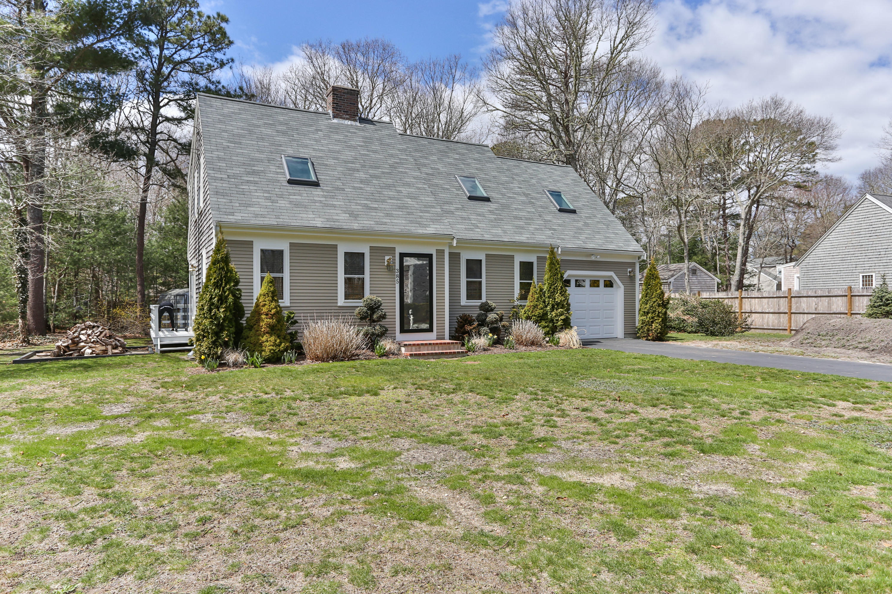 385 Skunknet Road Centerville, MA 02632 - Photo 2 of 32 a view of a house with backyard porch and garden