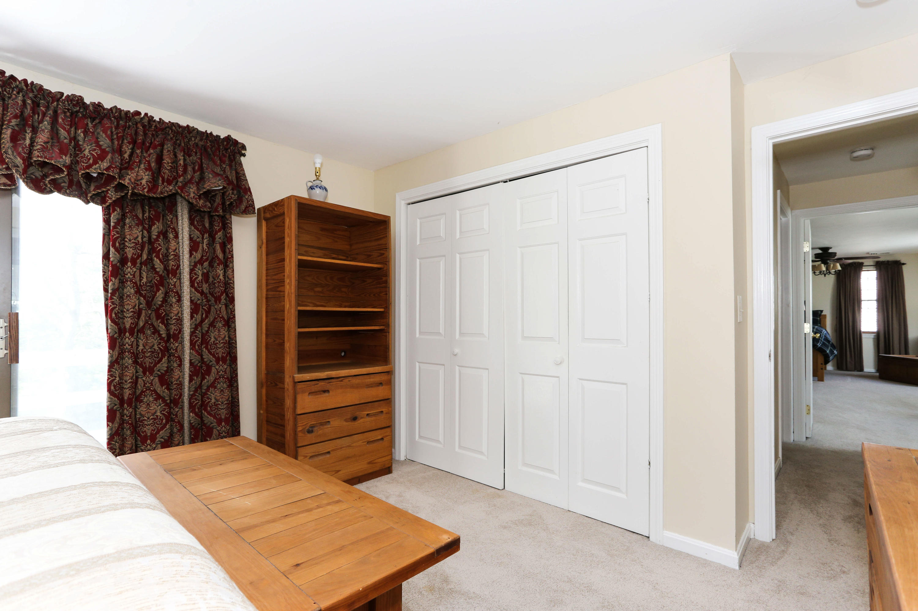 385 Skunknet Road Centerville, MA 02632 - Photo 22 of 32 a bedroom with a bed and a walk in closet