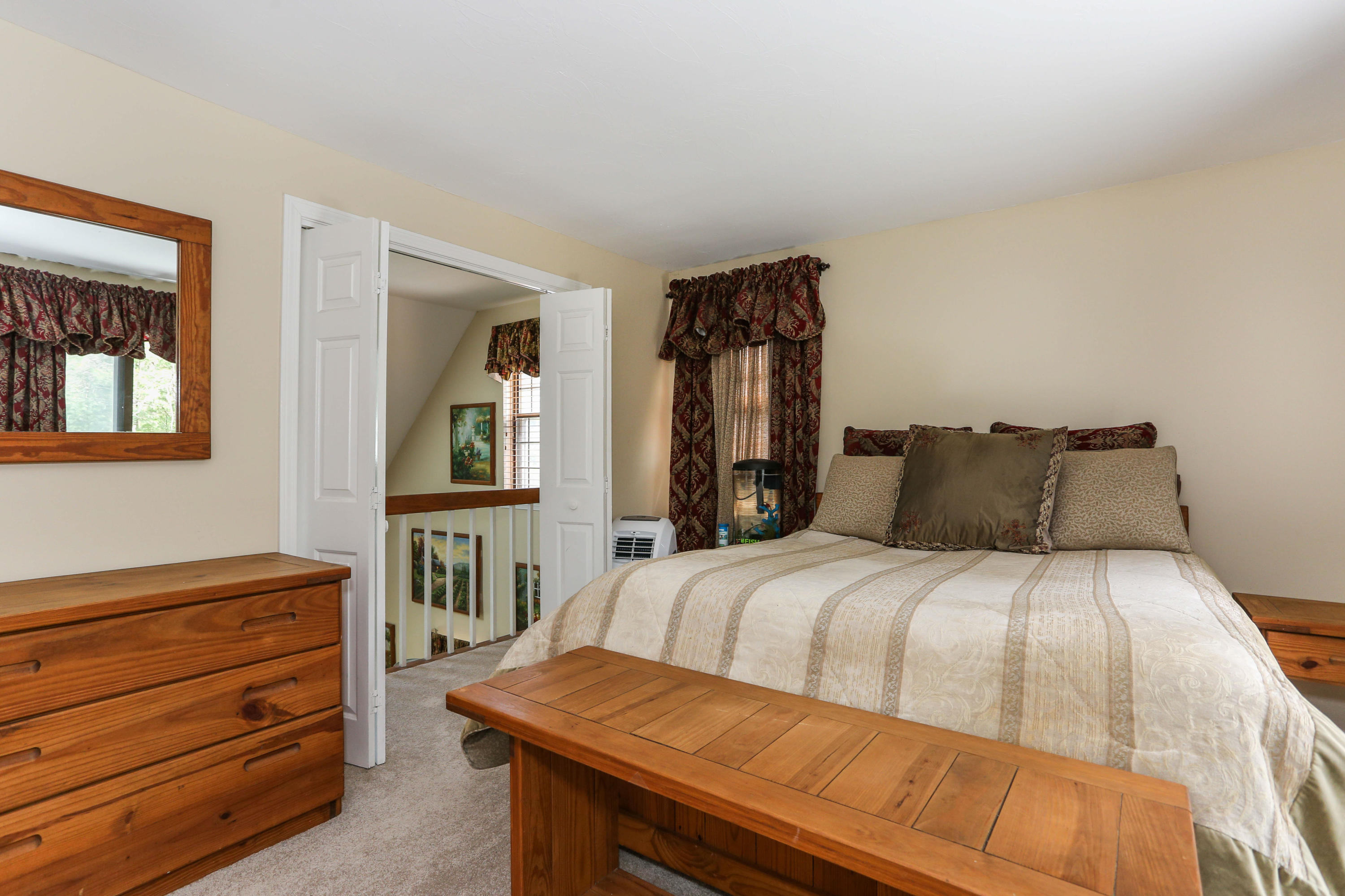 385 Skunknet Road Centerville, MA 02632 - Photo 23 of 32 a bedroom with a bed and a dresser