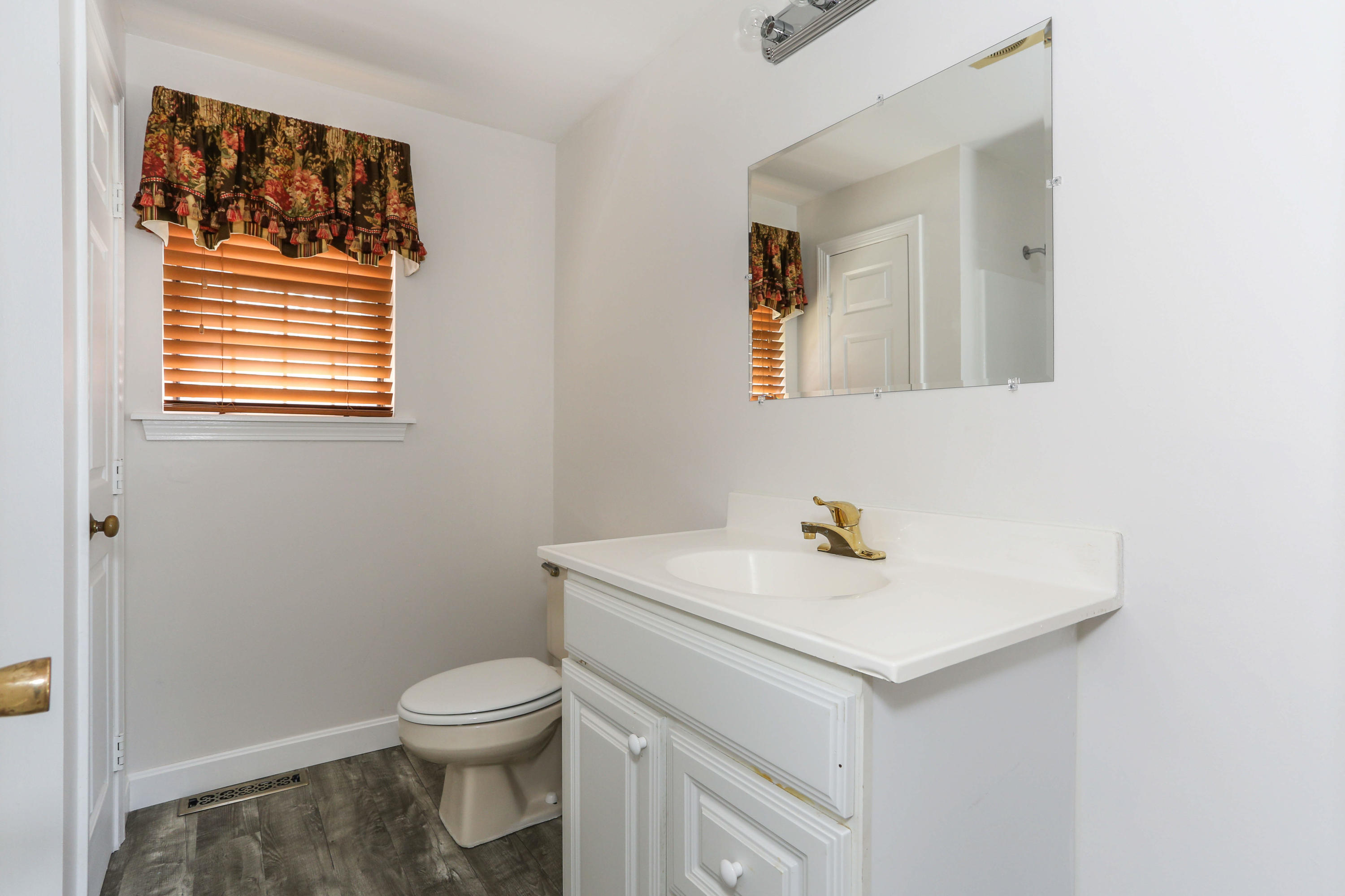 385 Skunknet Road Centerville, MA 02632 - Photo 24 of 32 a bathroom with a sink a toilet and mirror
