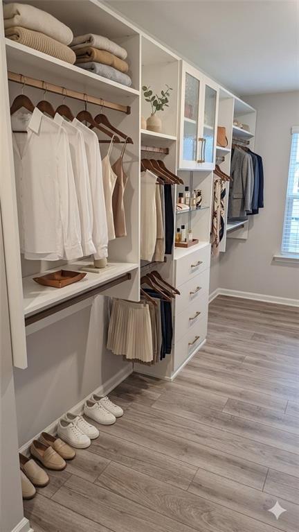 4830 Spangle Court Cumming, GA 30028 - Photo 13 of 18 a view of walk in closet with clothes and shoes