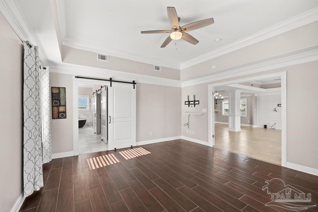 321 Gulfview Lane Perdido Key, FL 32507 - Photo 22 of 57 a view of an empty room with wooden floor and a ceiling fan