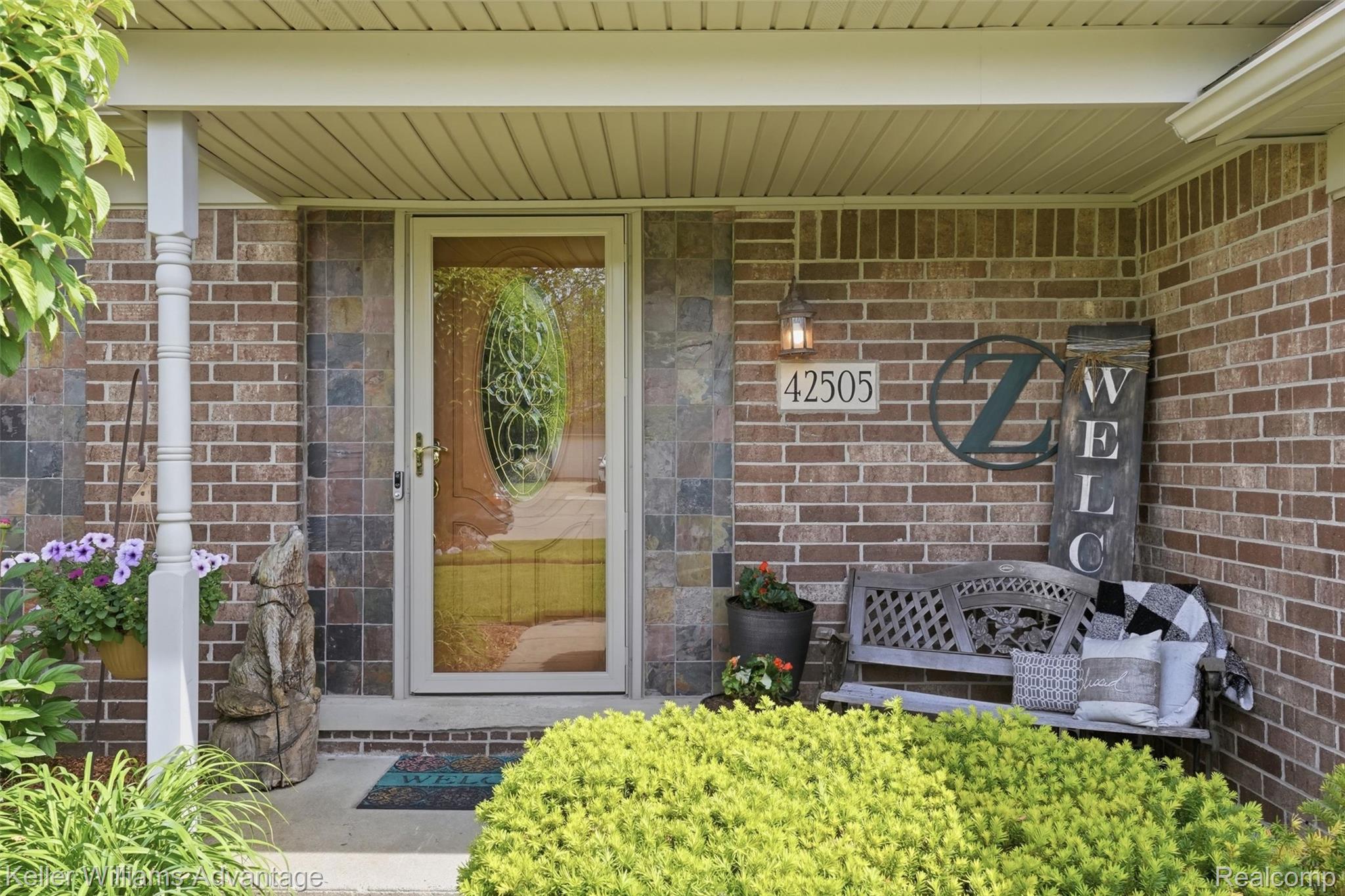 42505 Saltz Road Canton, MI 48187 - Photo 3 of 52 Doorway to property with covered porch and brick siding