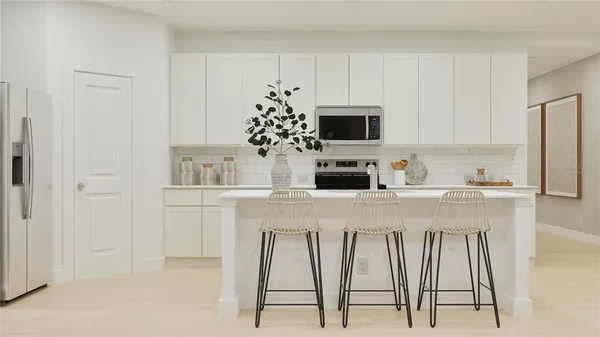 a kitchen with appliances a sink and cabinets