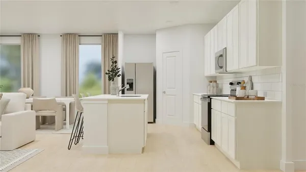 a kitchen with white cabinets and refrigerator