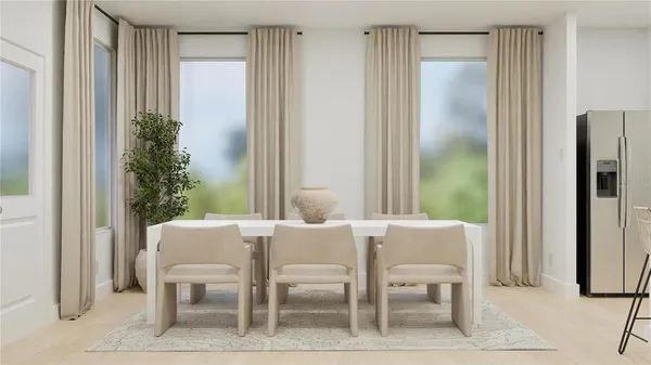 a view of a dining room with furniture and a potted plant