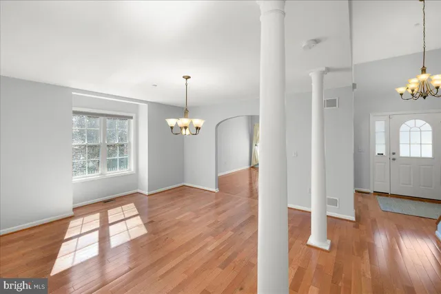 a view of an entryway with wooden floor