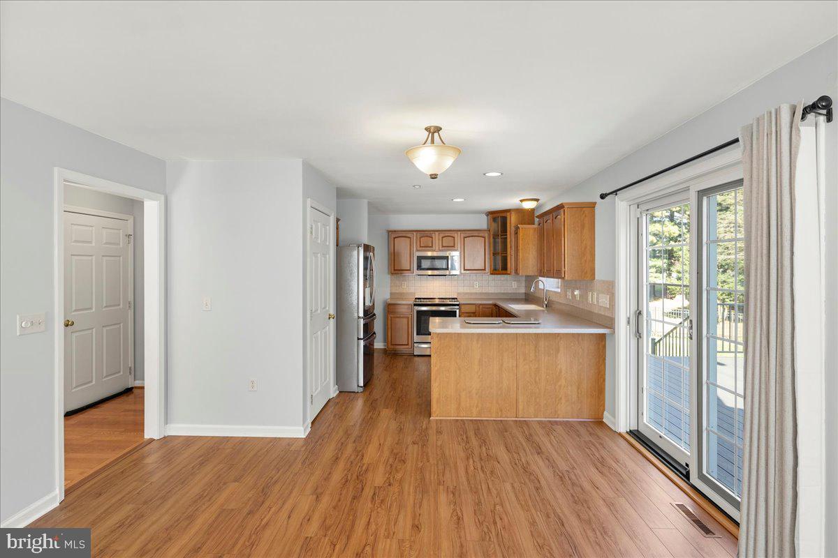8 Pheasant Trail Fairfield, PA 17320 - Photo 22 of 69 a kitchen with stainless steel appliances granite countertop a refrigerator a sink dishwasher a stove and white countertops with wooden floor