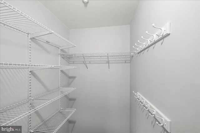 an aerial view of a city with lots of residential buildings ocean and mountain view in back