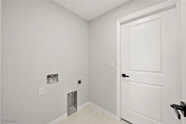 a view of a hallway with white walls and chandelier