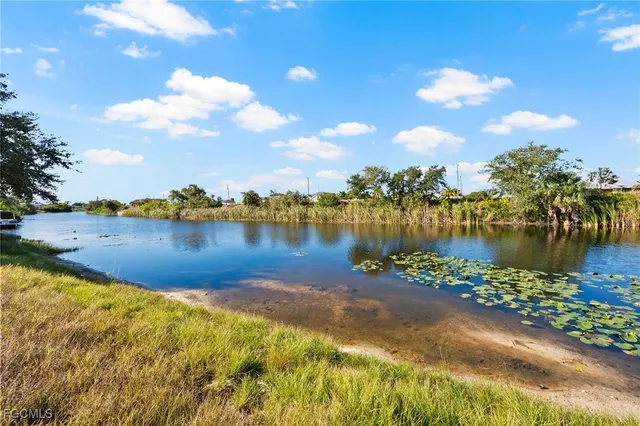 a view of a lake with houses in the background