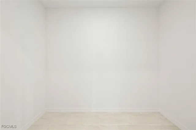 a bathroom with white cabinets and a sink