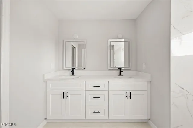 a view of a white house with a yard and potted plants