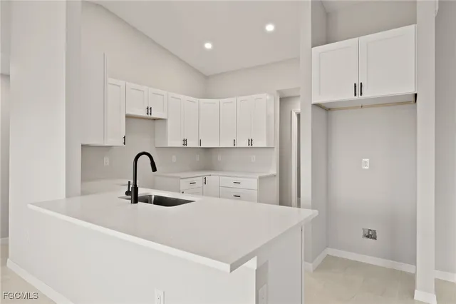 a kitchen with white cabinets
