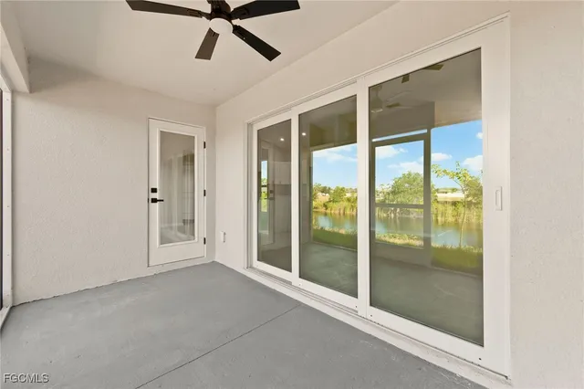 a view of a balcony with lake view and floor to ceiling window