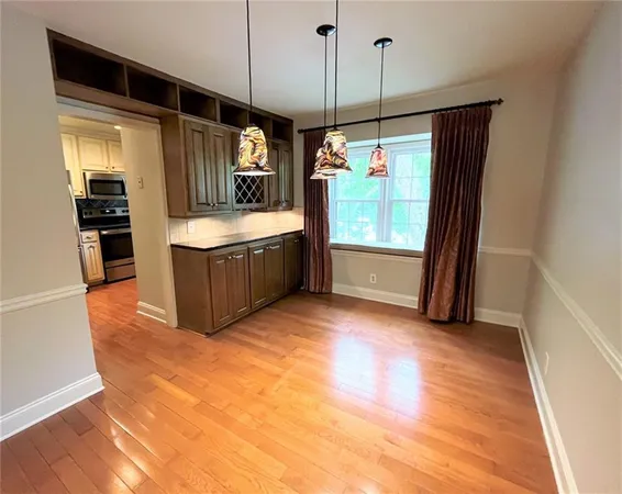 a kitchen with stainless steel appliances granite countertop a refrigerator a sink and a stove