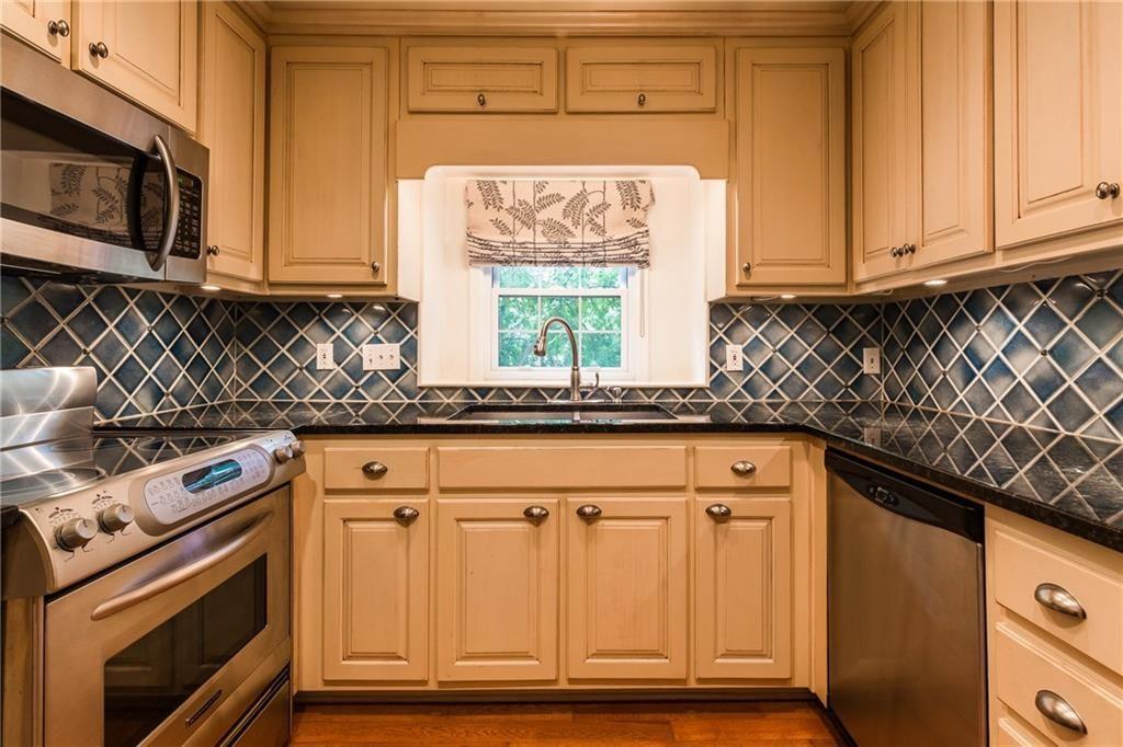 82 Montre Square Northwest Atlanta, GA 30327 - Photo 16 of 44 a kitchen with granite countertop cabinets stainless steel appliances and a sink