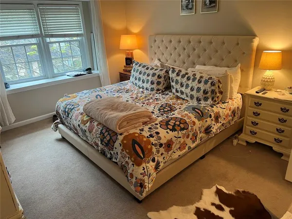 a bed sitting in a bedroom next to a window