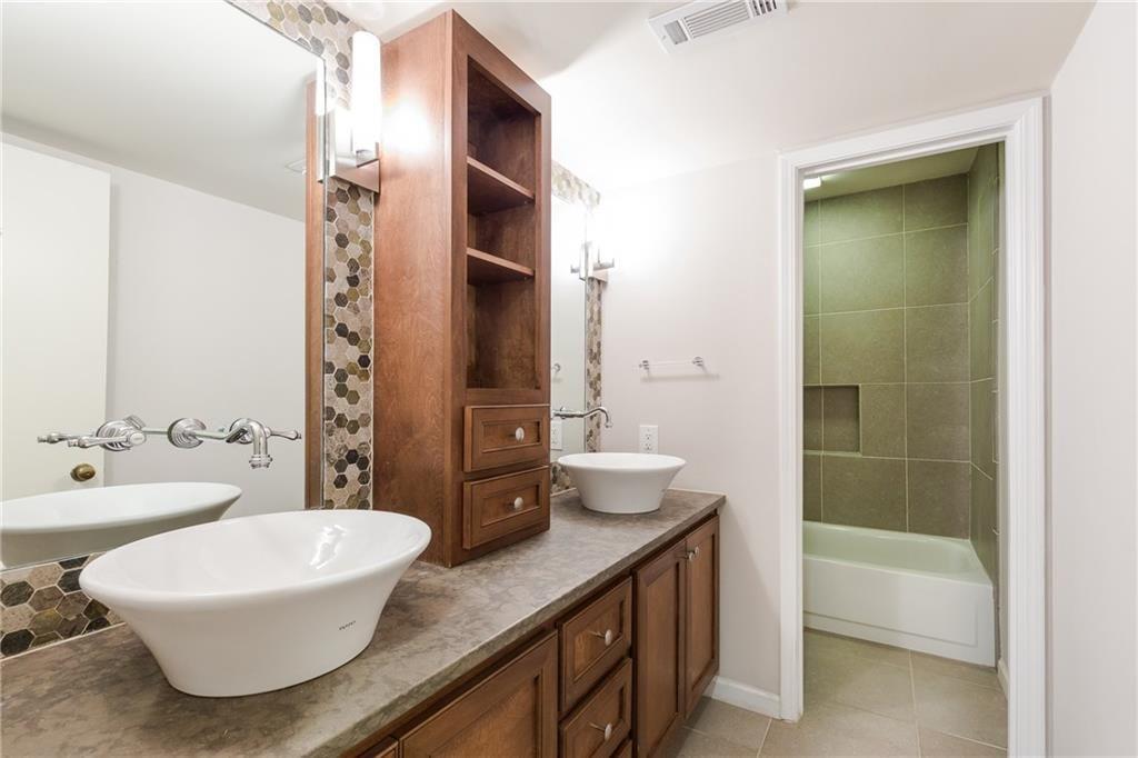 82 Montre Square Northwest Atlanta, GA 30327 - Photo 21 of 44 a bathroom with a double vanity sink toilet and shower