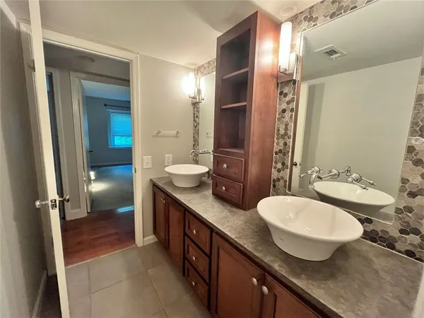 a bathroom with a sink and mirror