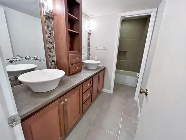 a bathroom with a double vanity sink and mirror