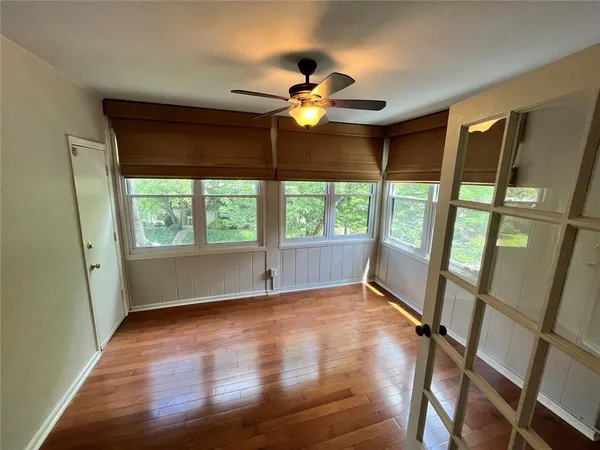 wooden floor in an empty room with a window