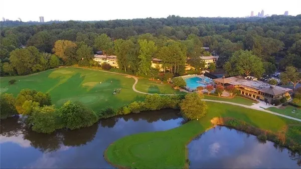an aerial view of a house with a garden and lake view