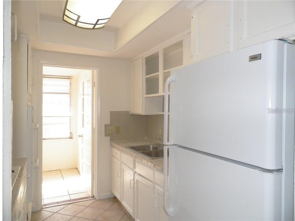 911 Washington Avenue Southwest, Unit 304 Largo, FL 33770 - Photo 9 of 26 a walk in closet with wooden floor