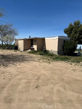 a kitchen with granite countertop a sink cabinets and stainless steel appliances