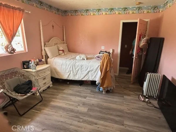 a bedroom with furniture and a window